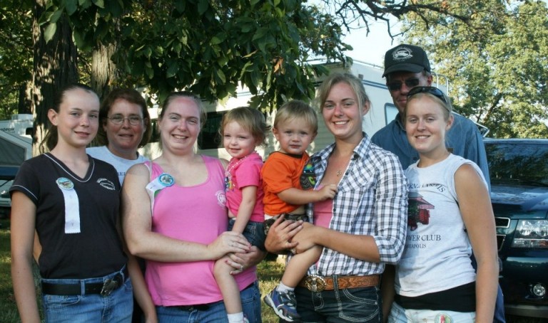 The Stevens family standing together outdoors, smiling at the camera.