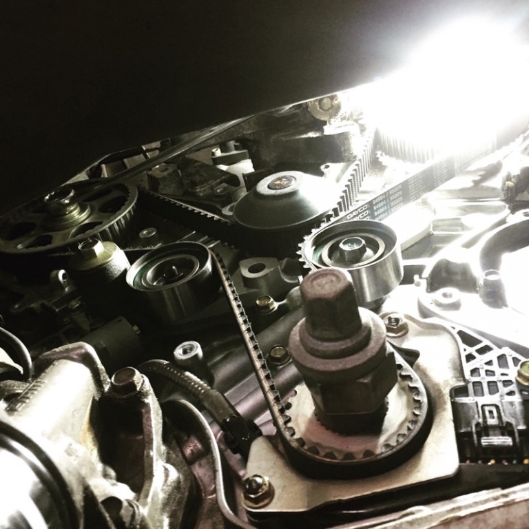 Timing components exposed during an engine belt replacement.