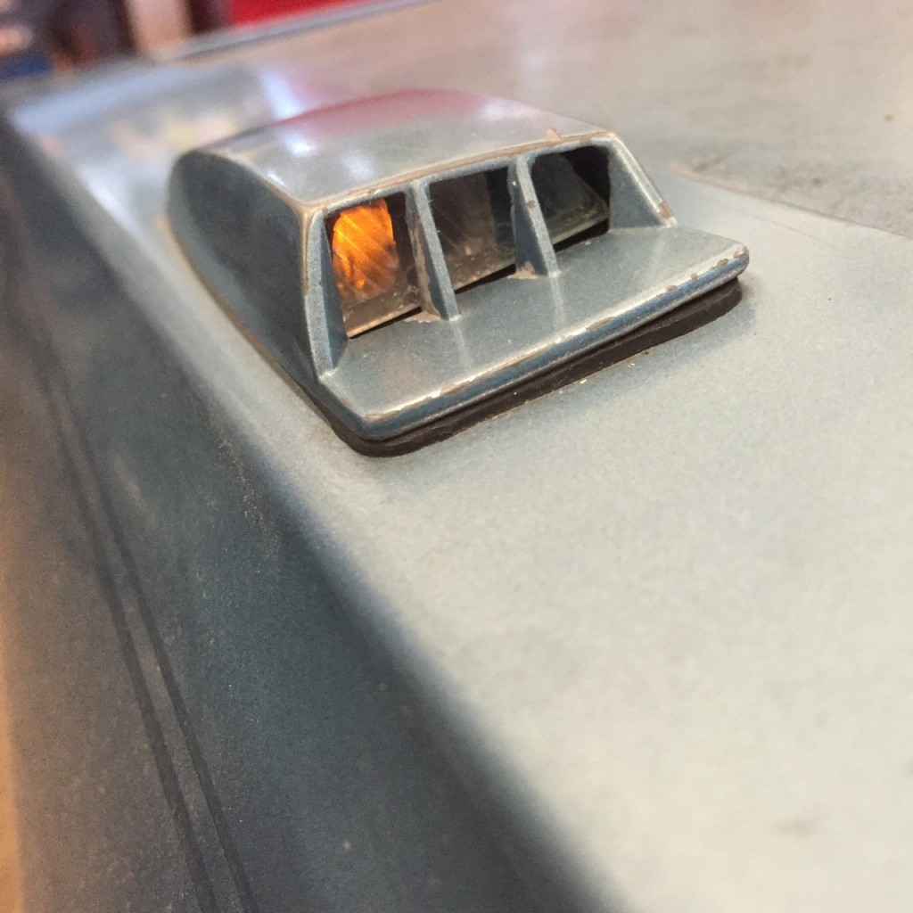 Close-up of an illuminated marker light on a classic vehicle.