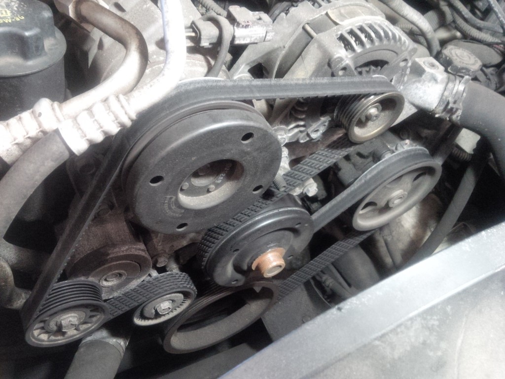 Incorrectly routed serpentine belt on an engine.