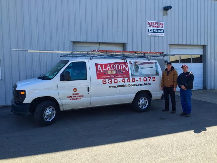 Service van for Aladdin Garage Doors parked outside Stevens Automotive.