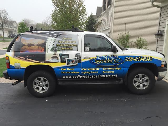 Audio Video Specialists service SUV parked in a driveway.
