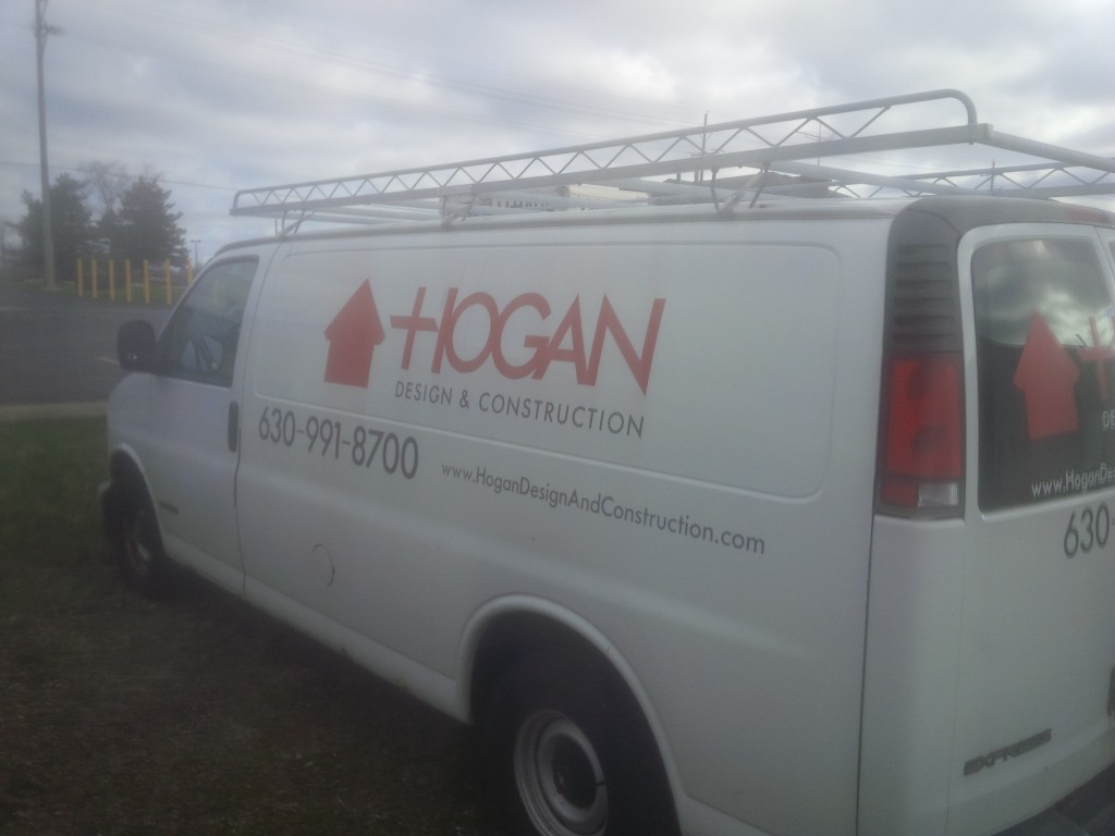 Hogan Design & Construction van parked near a job site.